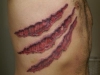 claw mark ribcage tattoo