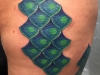 teal and green scale tattoo